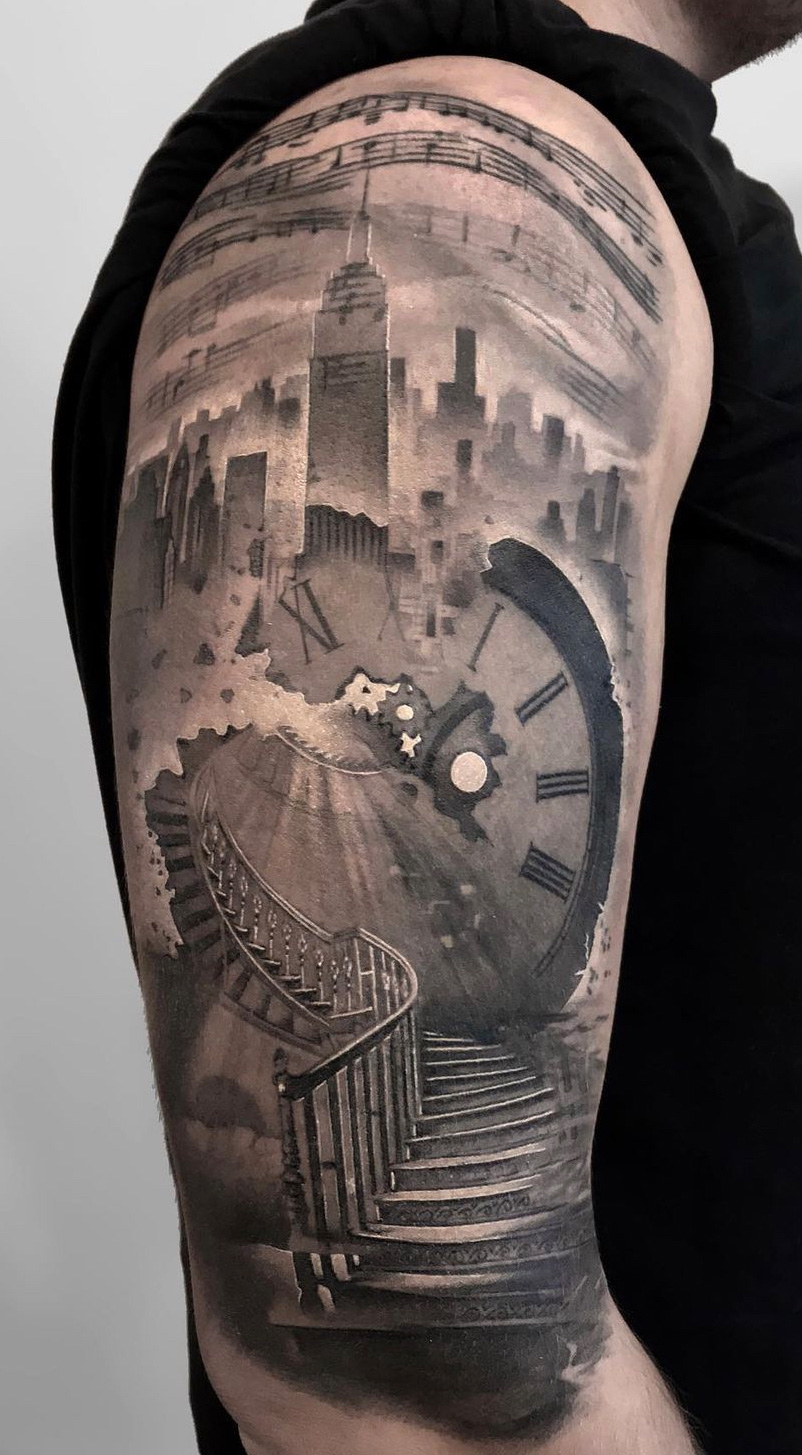 Tattoo-Anansi-Studio-Munchen-Munich-Haidhausen-Alex-upper-arm-shoulder-clock-clockwork-cracks-skyline-skyscrapers-staircase-stairs-time-is-running-best-black-and-grey-realism.jpg